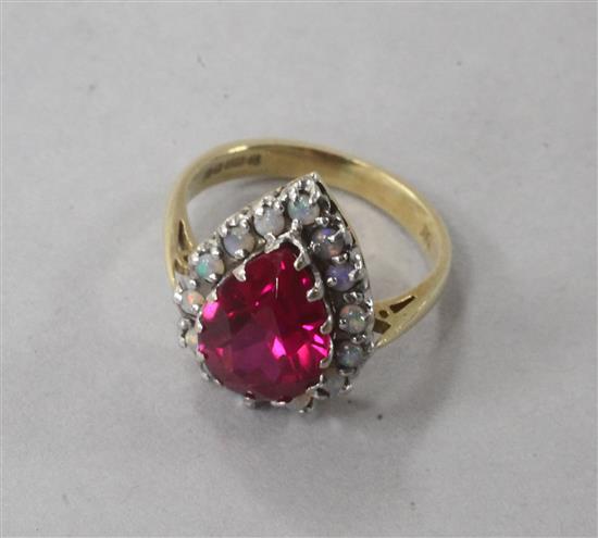An 18ct gold, pear shaped synthetic ruby and white opal cluster dress ring, size L.